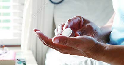 Mid section of senior citizen taking medicine in bedroom 4k
