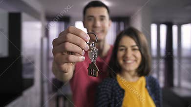 Husband and wife holding keys to new home