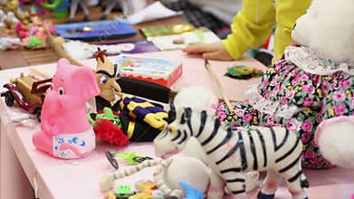 Many toys lying on table, children playing games at kindergarten or orphan home