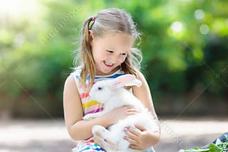 Child with rabbit. Easter bunny. Kids and pets.