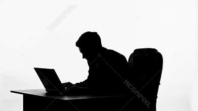Silhouette of writer thinking on idea, inspired writing new chapter on computer