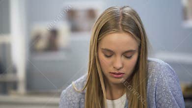 Student girl looking upset after phone talk with friend, date cancel, bad news