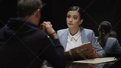 Beautiful lawyer at meeting with arrested man, preparation for court hearing