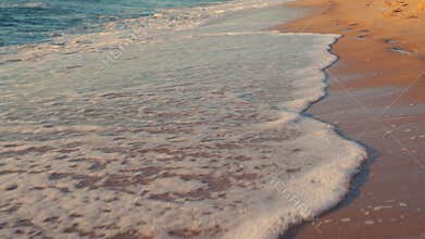 Tropical sunrise over the beach. Sea waves washing the sand