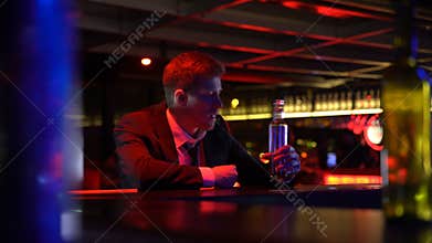Drunk man alone stays late in bar, finishes whiskey bottle, suffering depression