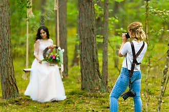 Professional wedding photographer taking close-up portraits of the bride