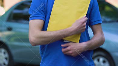 Courier giving document package, company delivery service, door to door shipping