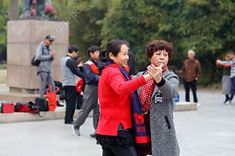 Two elderly women dancing tango, srgb image