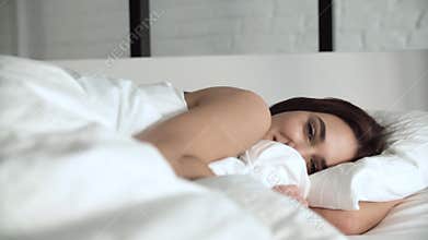 Happy Woman Waking Up In Comfortable Bed With White Linens