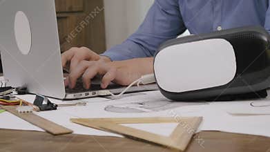 Close-up software engineer programming VR headset