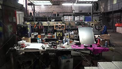 Desk of free space and workshop. Clip. Organized wall of tools and electricity plug. inside a workshop with large