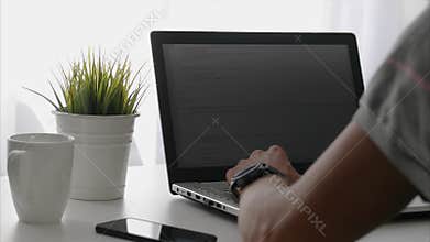 Freelance programmer working on laptop