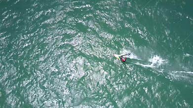 Surfer rides waves and makes foamy trace