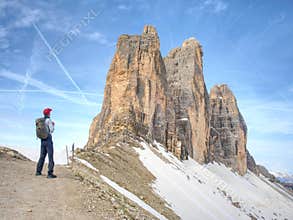 Backpacker on trip aound Tre Cime di Lavaredo in sunny April morning.