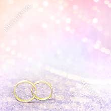 Pastel pink wedding background With Golden Rings