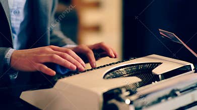Close up of the typewriter on which the text is typed. Learning concept. School children in uniform. Teacher in