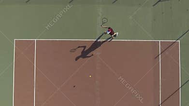Athletic woman in cap playing tennis, aerial view on female practicing shot