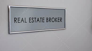 Real estate broker office door, hand knocking closeup, apartment purchase deal