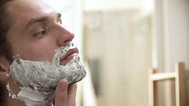 Men Hygiene. Male Applying Shaving Foam On Beard Closeup