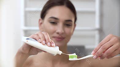 Teeth Hygiene. Woman Applying Toothpaste On Toothbrush Closeup