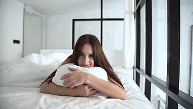 Beautiful Woman Lying On Comfortable Bed And Hugging Pillow