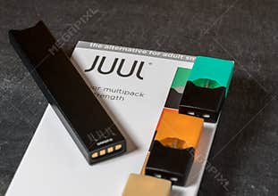 Box holding JUUL nicotine dispenser and pods