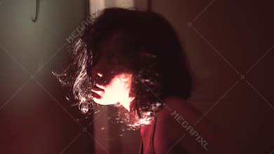 Creepy zombie woman face with wounds in dark