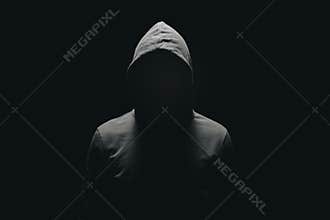 faceless man in hoodie standing