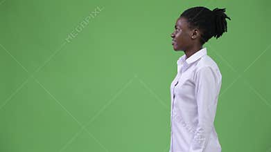 Profile view of young beautiful African businesswoman smiling