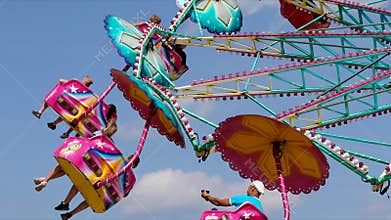 Amusement park chair carousel rotating against blue sky