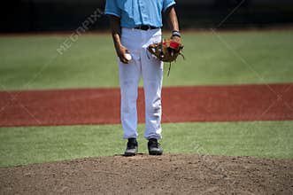 Baseball pitcher ready to pitch in an evening baseball game