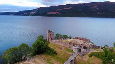 Loch Ness and Urquhart Castle in the evening - aerial drone footage
