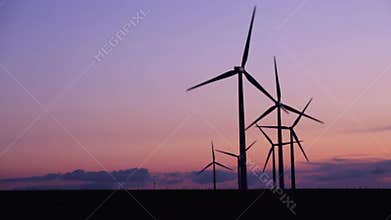 Wind turbines in the countryside under a beautiful sunset