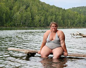 Overweight woman sitting on stage
