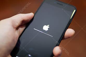 Apple iPhone 7 showing its screen with Apple logo when it is being updated the software to iOS 12