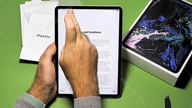 Man unboxing unpacking new Apple Computers iPad Pro
