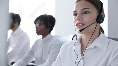 Call Center Agents Consulting Clients On Hotline At Office