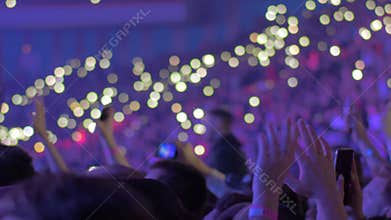 Large audience inside an arena during a concert