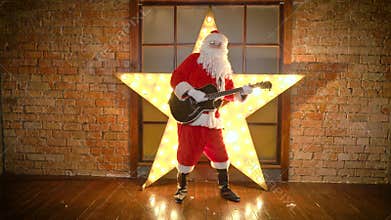 Santa Claus rock star, plays christmas songs by guitar, have fun, celebrate holidays
