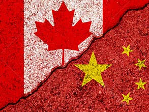 Flags of China and Canada painted on cracked grunge wall background/Canada and China relations and conflict concept