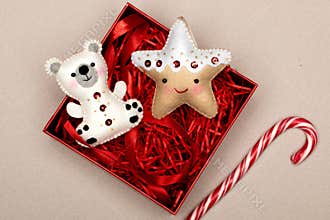 Handmade star and bear in a gift box with red tinsel