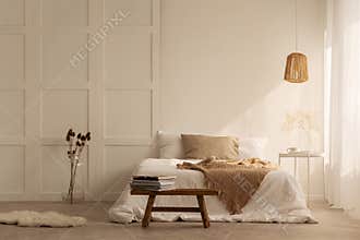 Double bed in stylish wabi sabi bedroom of minimal style house, real photo