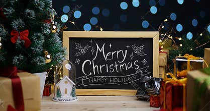 Merry Christmas Typography on Blackboard Between Christmas Decor