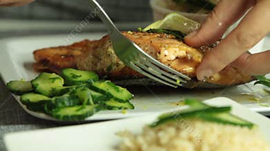 Woman cooking salmon fish at home