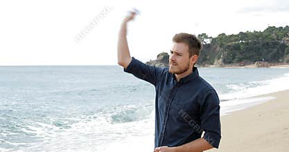 Worried man throwing stones to the ocean