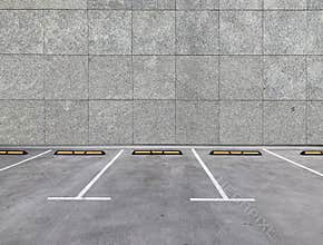 Parking spaces along building wall.