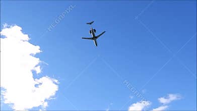 An airliner goes under the clouds