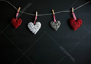 Four white and red hearts on black wooden table. Valentines, spring background. Mock up with copyspace. happy mothers day