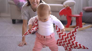 Mother with baby girl carrying star shape cushion