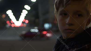 Helpless child standing alone on big city street difficult childhood and poverty